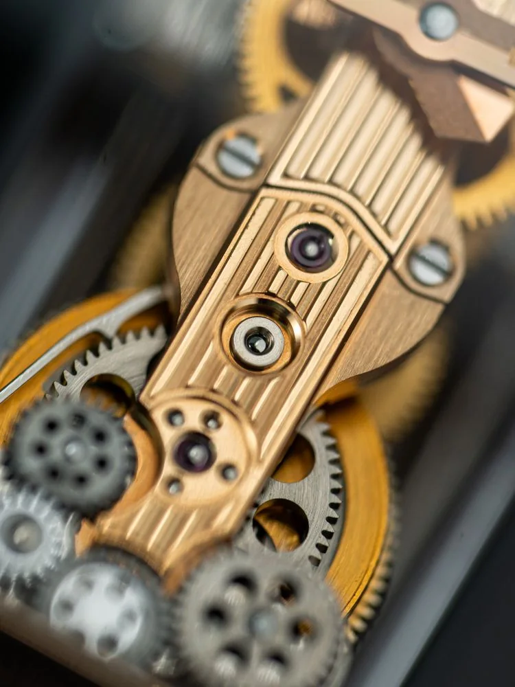 Mechanical watch gears in detail Macro view of gold and steel gears inside a mechanical watch.